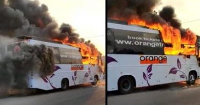 Orange travel bus catches fire.