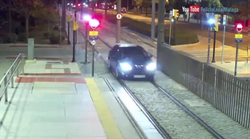 Drunk woman driving a car on a railway track